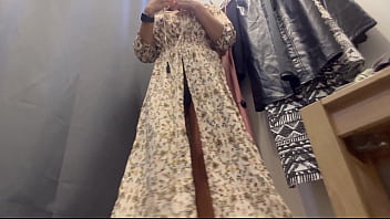 A sexy woman with big breasts and a big ass tries on clothes