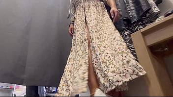 A sexy woman with big breasts and a big ass tries on clothes