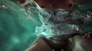 Babe in dress gets in the water to fuck