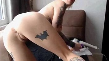 Tattooed blonde masturbates her shaved pussy with toyss