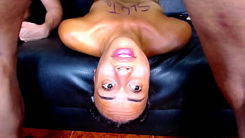 This whore lies on the couch swallowing cock upside down