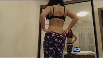 Dark haired beauty rubs pussy with enchanting gaze