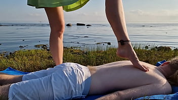 Foot massage by girl with long toes long slim legs in skirt