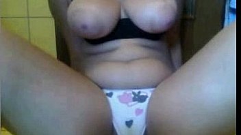 Brunette teen shows her tits and puts a finger in her pussy