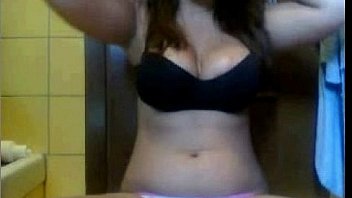 Brunette teen shows her tits and puts a finger in her pussy