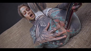 Tattoo slut sinks a thick metal toy deep into her hole