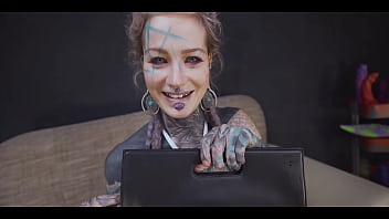 Tattoo slut sinks a thick metal toy deep into her hole