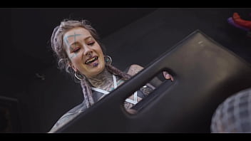 Tattoo slut sinks a thick metal toy deep into her hole