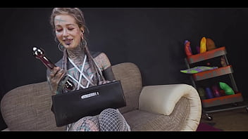 Tattoo slut sinks a thick metal toy deep into her hole