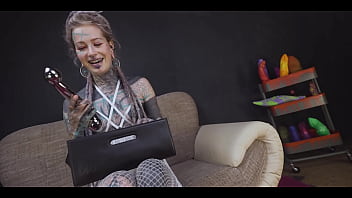 Tattoo slut sinks a thick metal toy deep into her hole