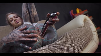 Tattoo slut sinks a thick metal toy deep into her hole