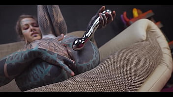 Tattoo slut sinks a thick metal toy deep into her hole