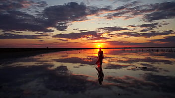 Pink sunset and mature woman