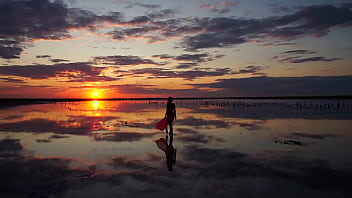Pink sunset and mature woman