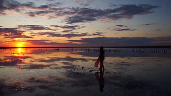 Pink sunset and mature woman
