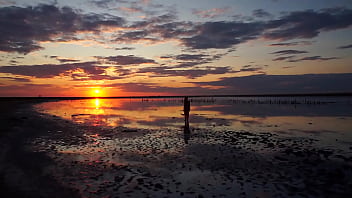 Pink sunset and mature woman