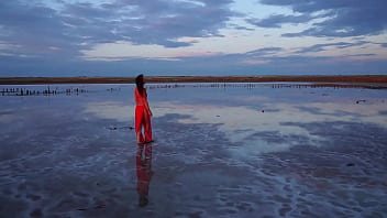 Pink sunset and mature woman
