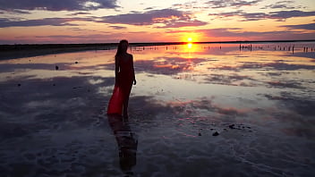 Pink sunset and mature woman