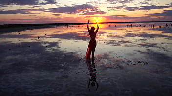Pink sunset and mature woman