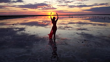 Pink sunset and mature woman