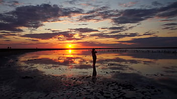 Pink sunset and mature woman