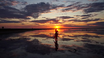 Pink sunset and mature woman