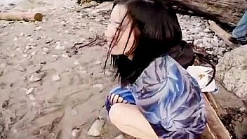 Asian slut is on the beach naked posing Asian slut is on the beach naked posing