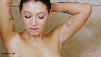 Striking brunette beauty enjoys a sensual bath