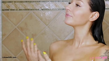 Striking brunette beauty enjoys a sensual bath