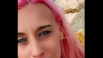 Cumshot partially lands on her face while the rest blends with the sea