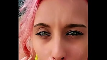 Cumshot partially lands on her face while the rest blends with the sea