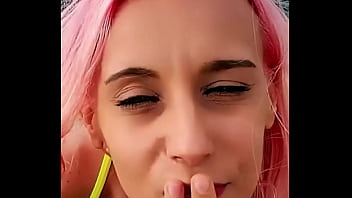 Cumshot partially lands on her face while the rest blends with the sea