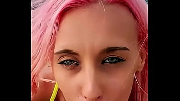 Cumshot partially lands on her face while the rest blends with the sea