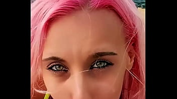 Cumshot partially lands on her face while the rest blends with the sea