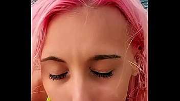 Cumshot partially lands on her face while the rest blends with the sea