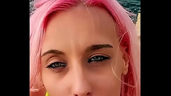 Cumshot partially lands on her face while the rest blends with the sea