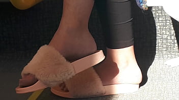 Shoeplay of stupid hot brunette with gorgeous feet wearing slides on train