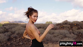 Petite all natural russian beauty poses naked on the rocks