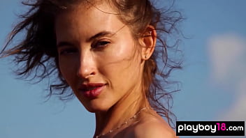 Petite all natural russian beauty poses naked on the rocks