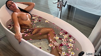 Bath of naked milf masturbates among flowers
