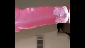 Fucking herself with large pink dildo