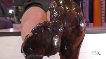 Goddess messy her nylon feet in chocolate close up and squeezing strawberries